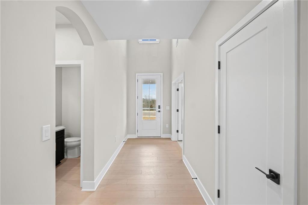 714 Conley Drive Canton, GA 30115 - Photo 9 of 51 a view of a hallway with wooden floor and a bathroom