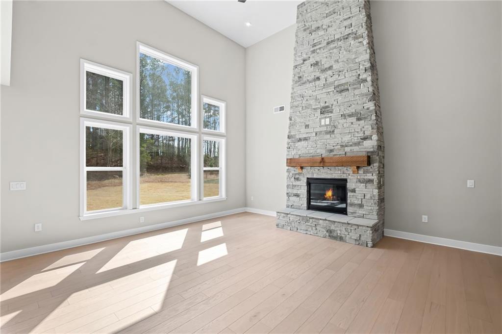 714 Conley Drive Canton, GA 30115 - Photo 10 of 51 an empty room with a fireplace and windows
