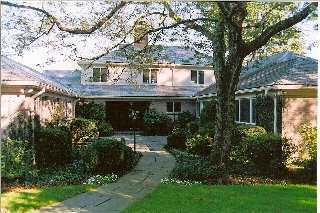 Undisclosed Address Darien, CT 06820 - Photo 3 of 8 a front view of house with a garden