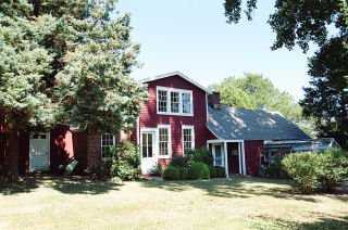 Undisclosed Address Darien, CT 06820 - Photo 5 of 8 a view of a brick house with a large windows and large trees
