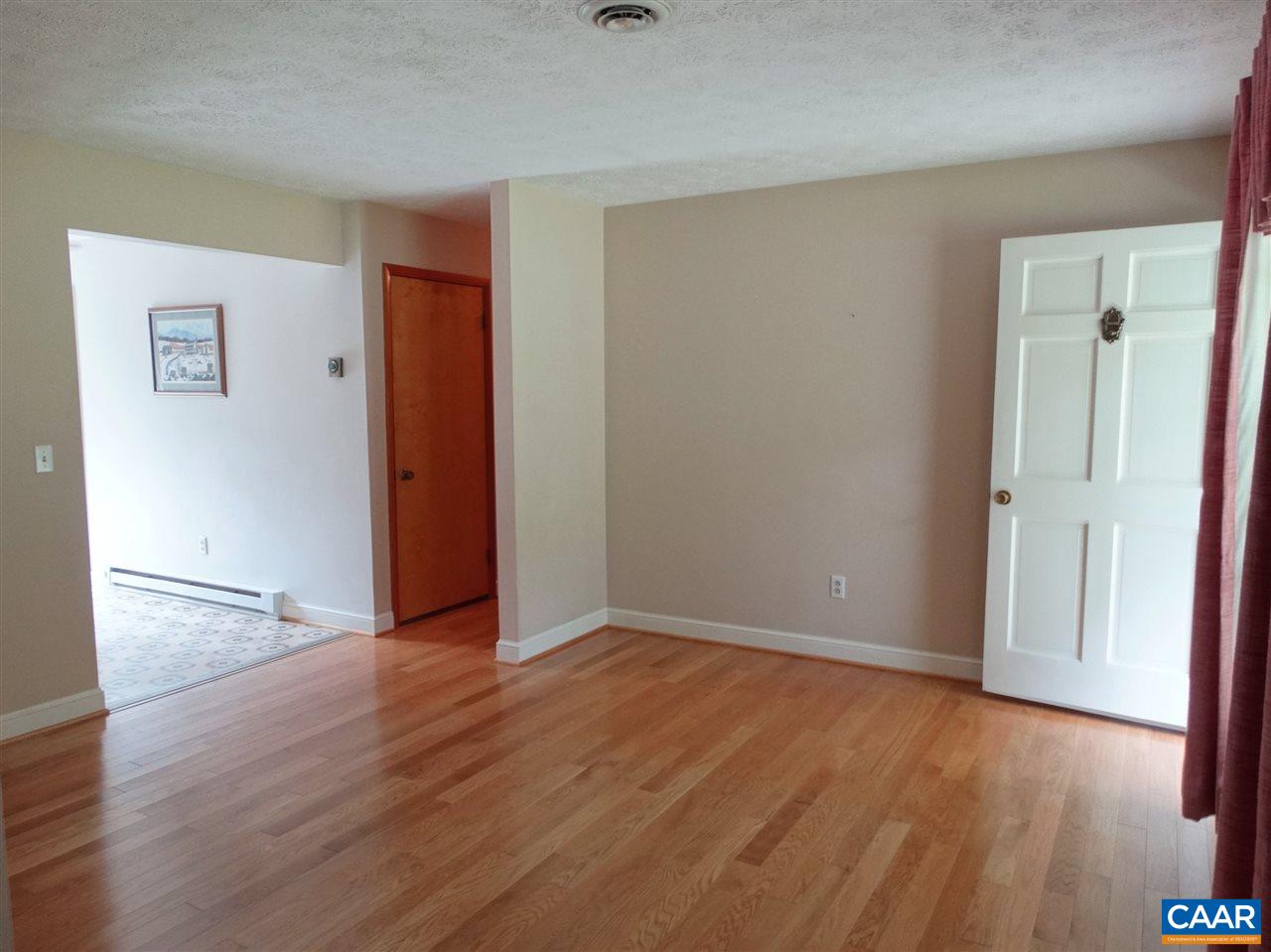 992 Advance Mills Road Ruckersville, VA 22968 - Photo 13 of 34 an empty room with wooden floor and bathroom