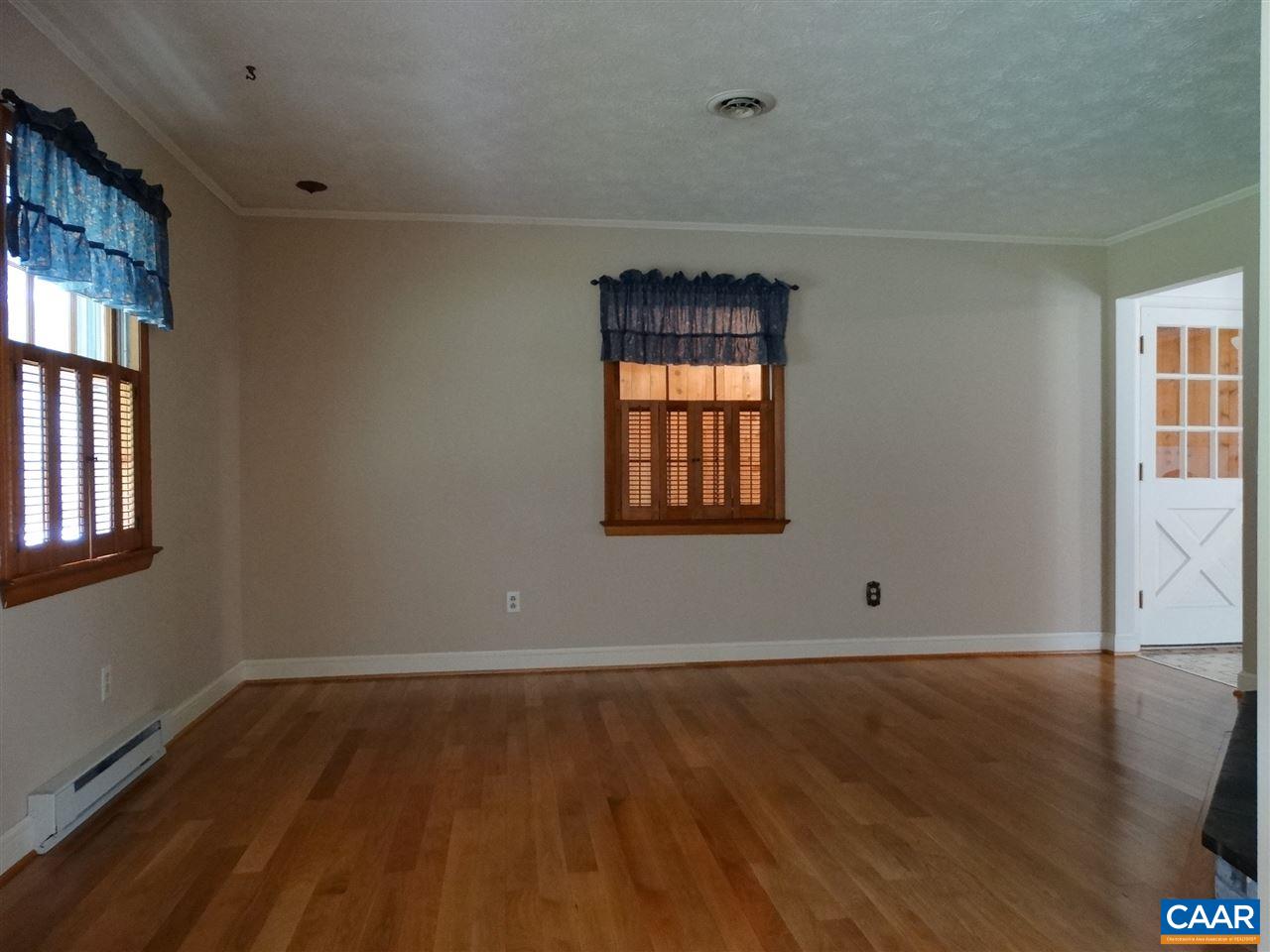 992 Advance Mills Road Ruckersville, VA 22968 - Photo 14 of 34 an empty room with wooden floor and windows