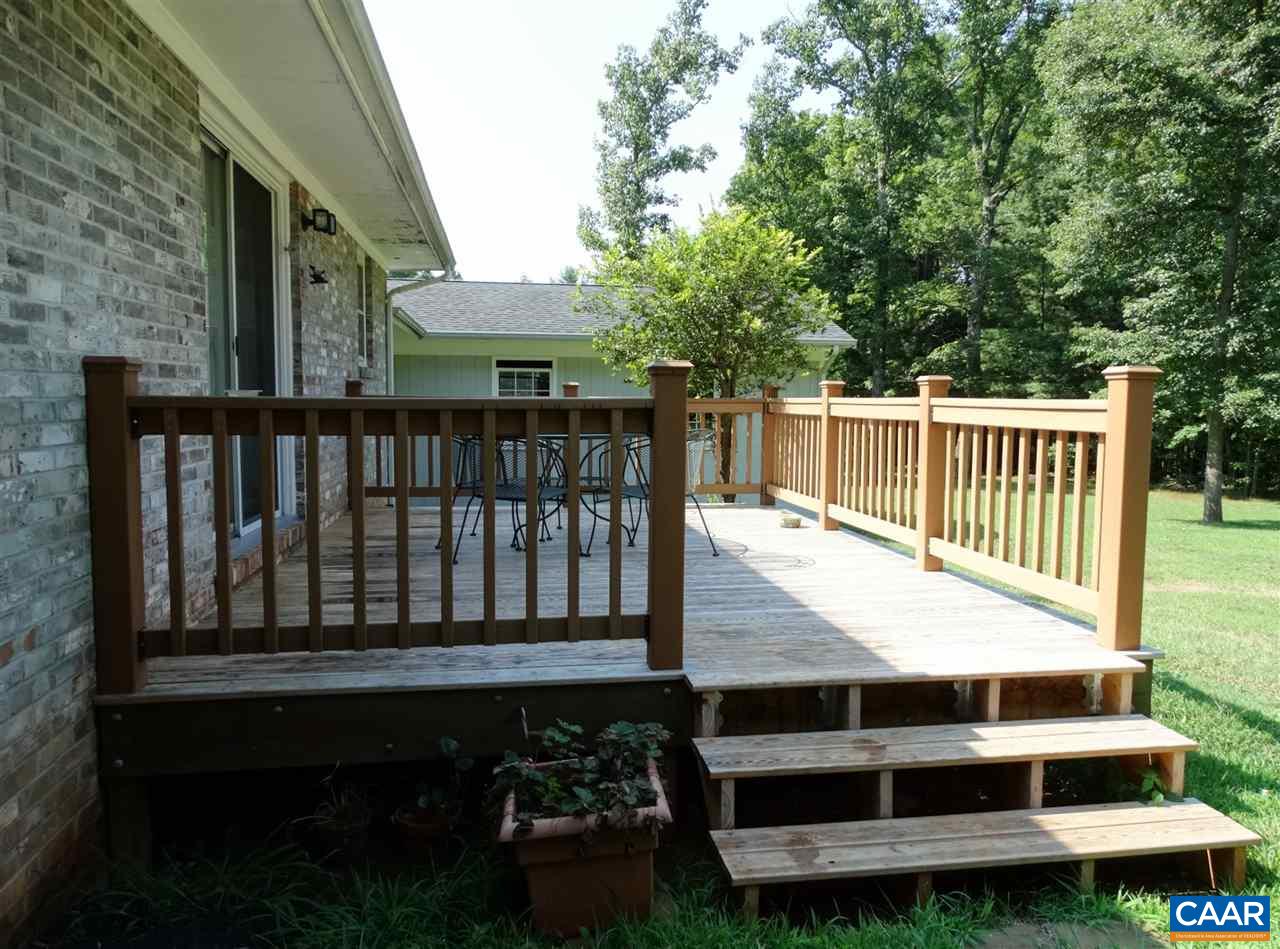 992 Advance Mills Road Ruckersville, VA 22968 - Photo 7 of 34 a view of a wooden deck and a yard with a garden