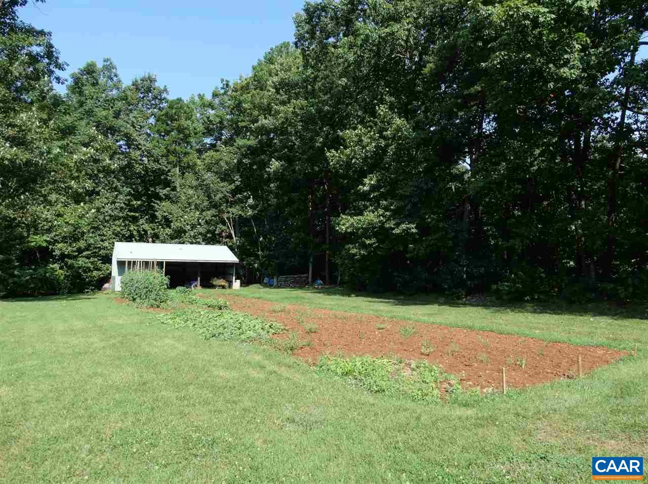 992 Advance Mills Road Ruckersville, VA 22968 - Photo 9 of 34 a view of backyard with a barn and large trees