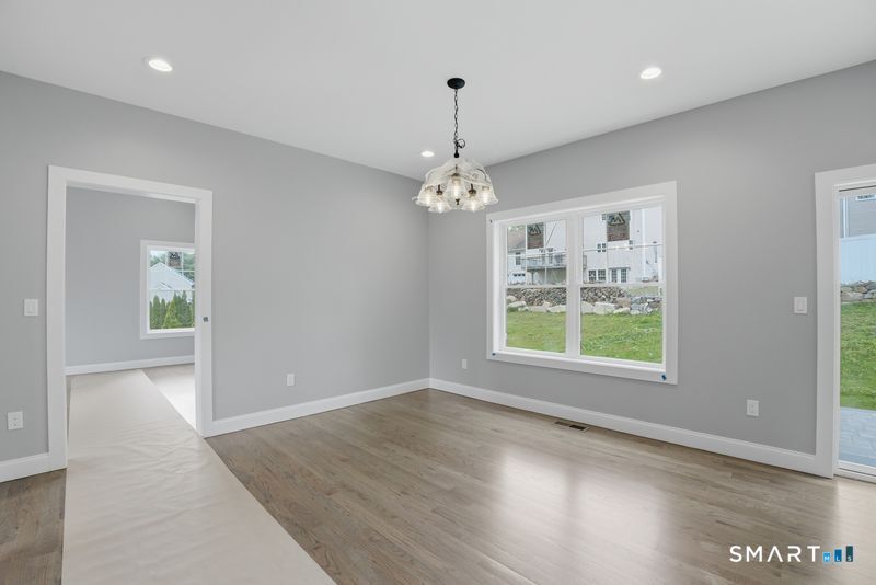 796 Maple Hill Road Naugatuck, CT 06770 - Photo 9 of 35 an empty room with wooden floor and windows