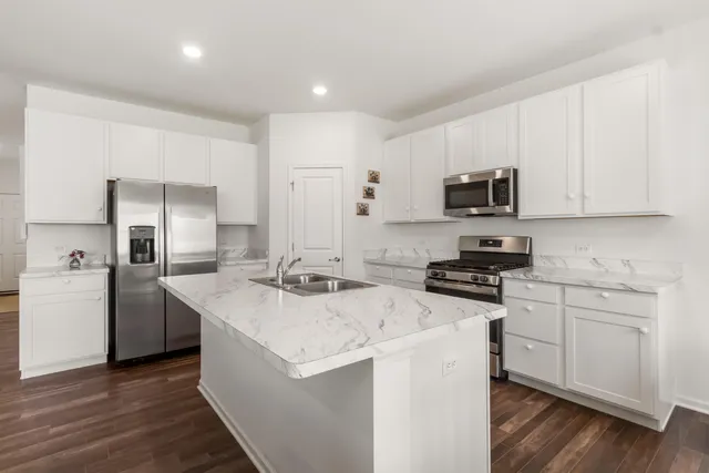 a kitchen that has a sink and a stove in it