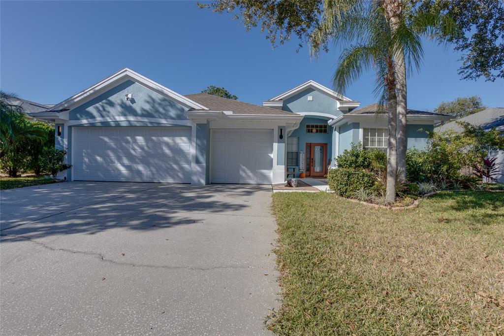 480 Bridle Path Way Tarpon Springs, FL 34688 - Photo 1 of 1 a front view of a house with a yard and palm tree