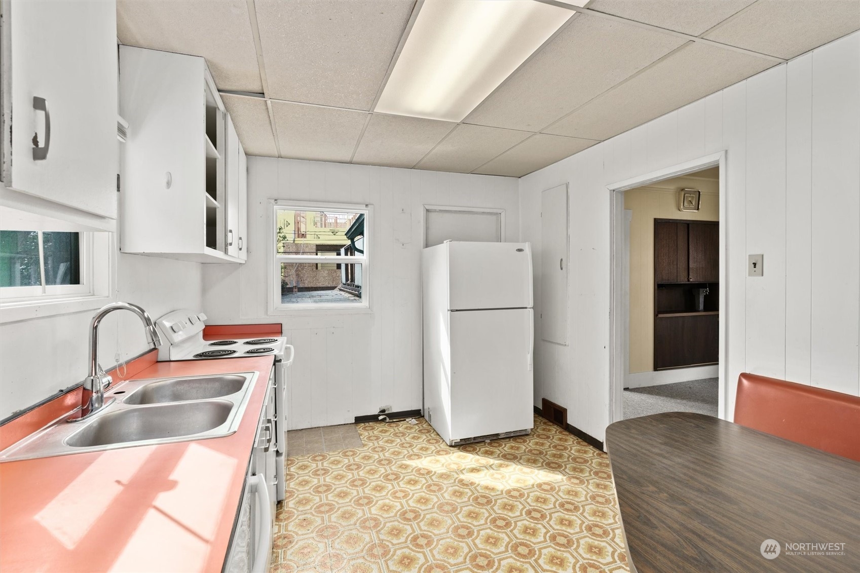 2813 15th Avenue South Seattle, WA 98144 - Photo 11 of 32 a kitchen with refrigerator sink and cabinets
