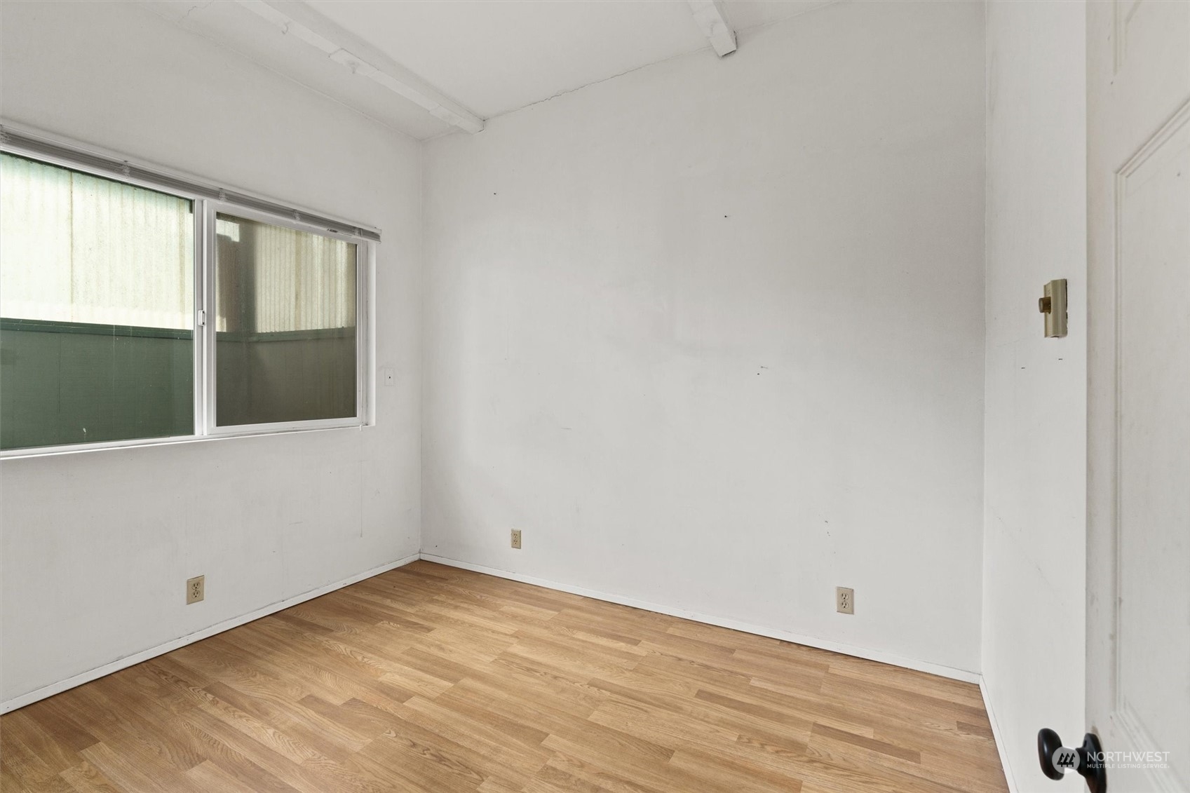 2813 15th Avenue South Seattle, WA 98144 - Photo 13 of 32 a view of an empty room with wooden floor and windows