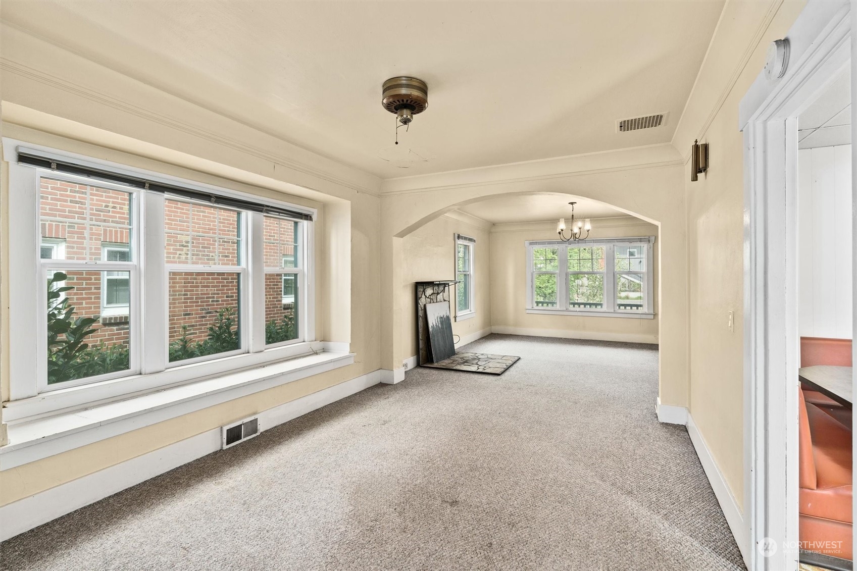 2813 15th Avenue South Seattle, WA 98144 - Photo 6 of 32 an empty room with a fireplace and large windows