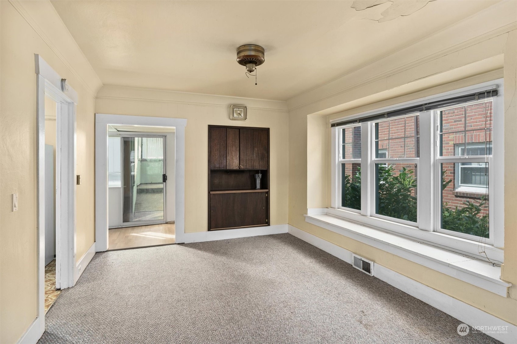 2813 15th Avenue South Seattle, WA 98144 - Photo 8 of 32 a view of an empty room with a window and a kitchen