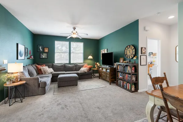a living room with furniture a window and a flat screen tv