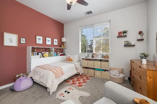 a bedroom with a bed and a couch