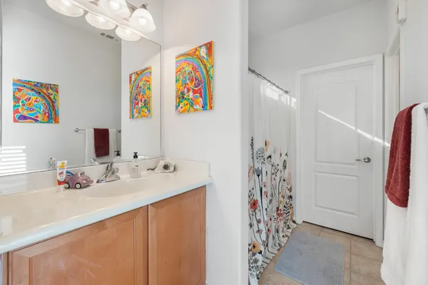 a bathroom with a sink a mirror and a shower