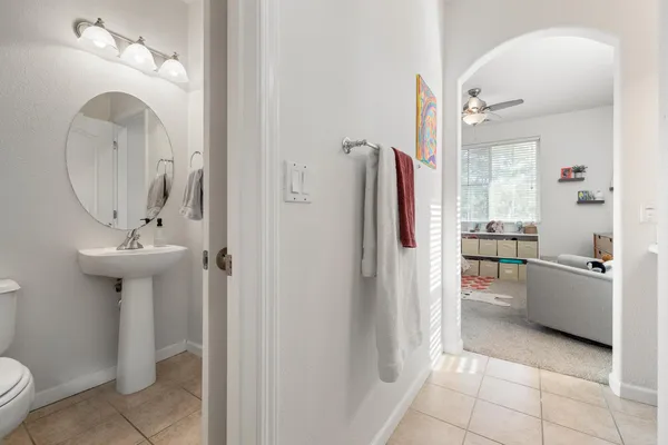 a bathroom with a sink a toilet and a mirror