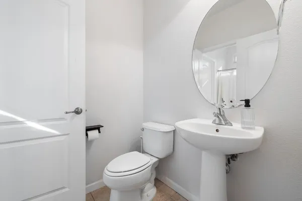 a bathroom with a sink a toilet and mirror