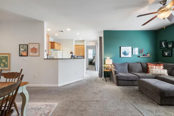 a living room with furniture and a wooden floor