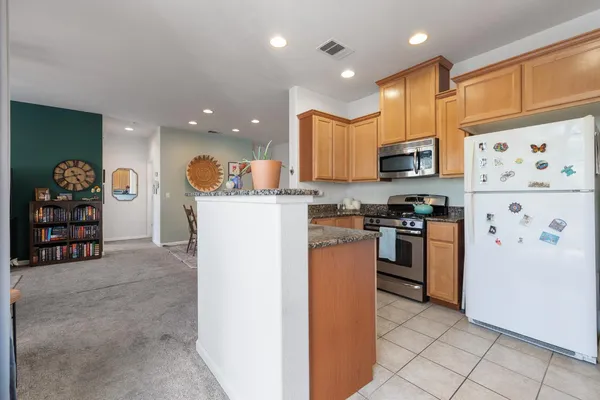 a kitchen with stainless steel appliances a refrigerator and a stove top oven