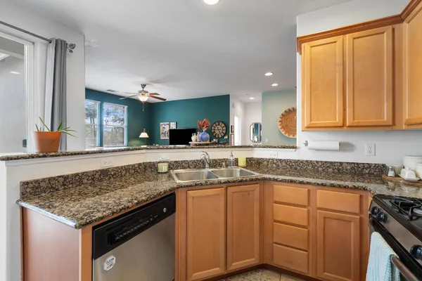 a kitchen with a sink stove and cabinets