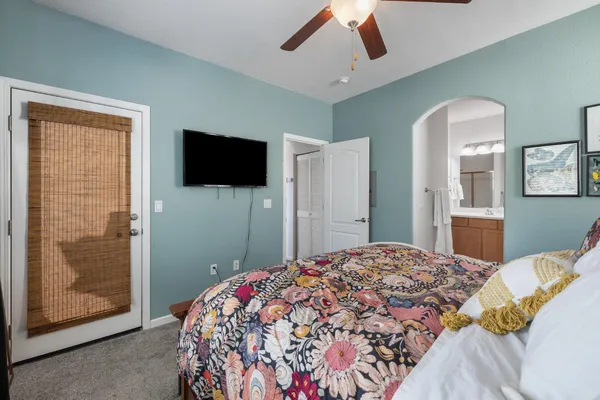 a bedroom with a bed and a flat screen tv