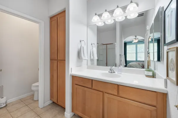 a bathroom with a sink vanity and a mirror
