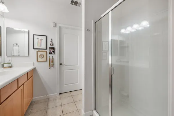 a bathroom with a shower sink and mirror
