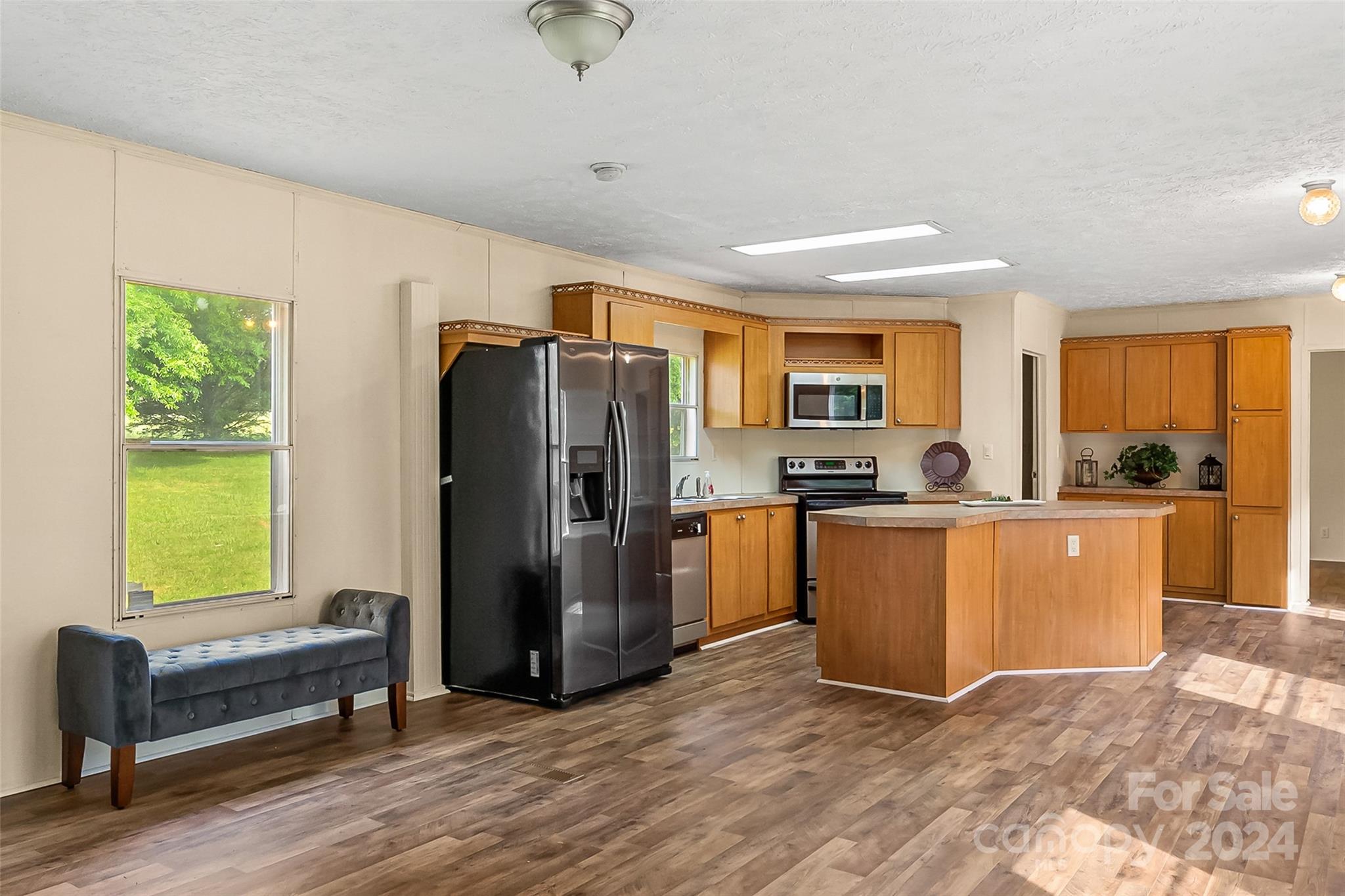 3836 River Road Hickory, NC 28602 - Photo 3 of 22 a kitchen with refrigerator a window and a counter top space