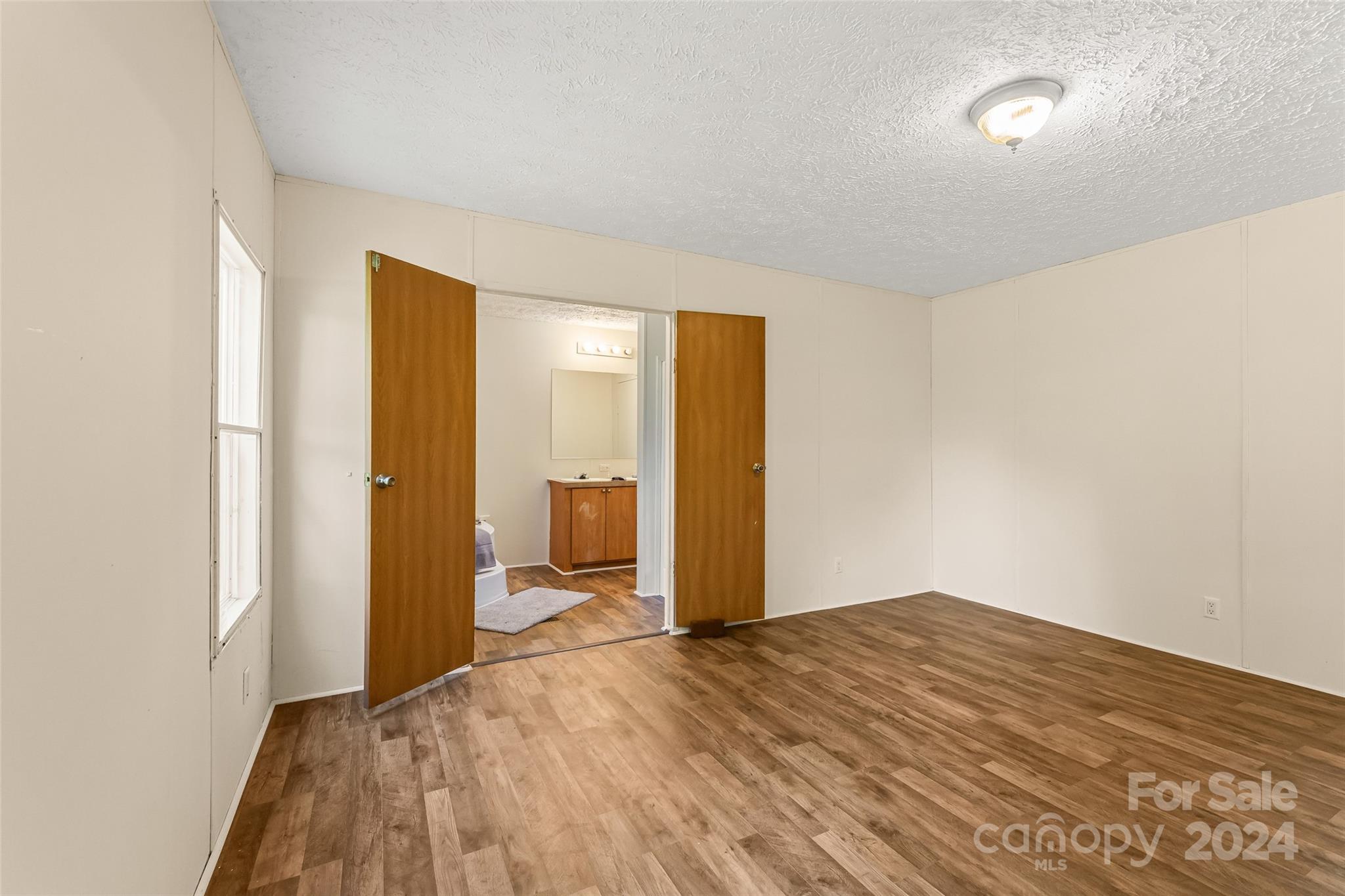 3836 River Road Hickory, NC 28602 - Photo 6 of 22 a big room with wooden floor and bathroom view