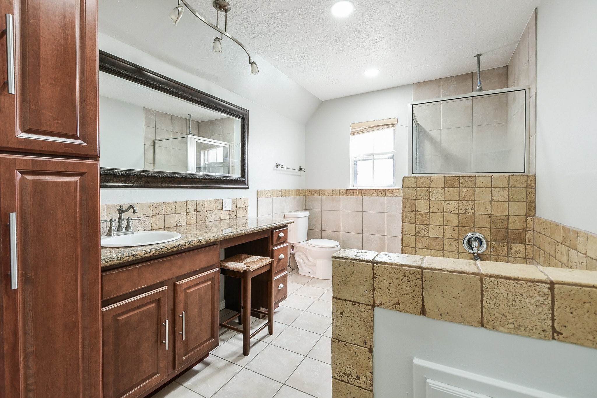 1007 Maranon Lane Houston, TX 77090 - Photo 26 of 36 Your primary bathroom is a delightful retreat, offering ample space to prepare for the day ahead while seamlessly enjoying each other’s company. It’s a perfect blend of comfort and elegance, ensuring that you can both get ready without missing a beat!