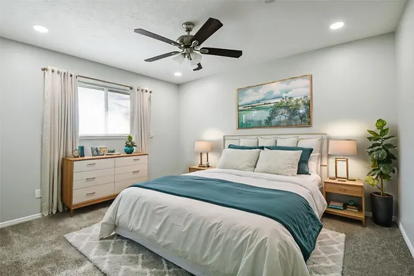 a bedroom with a large bed and a window