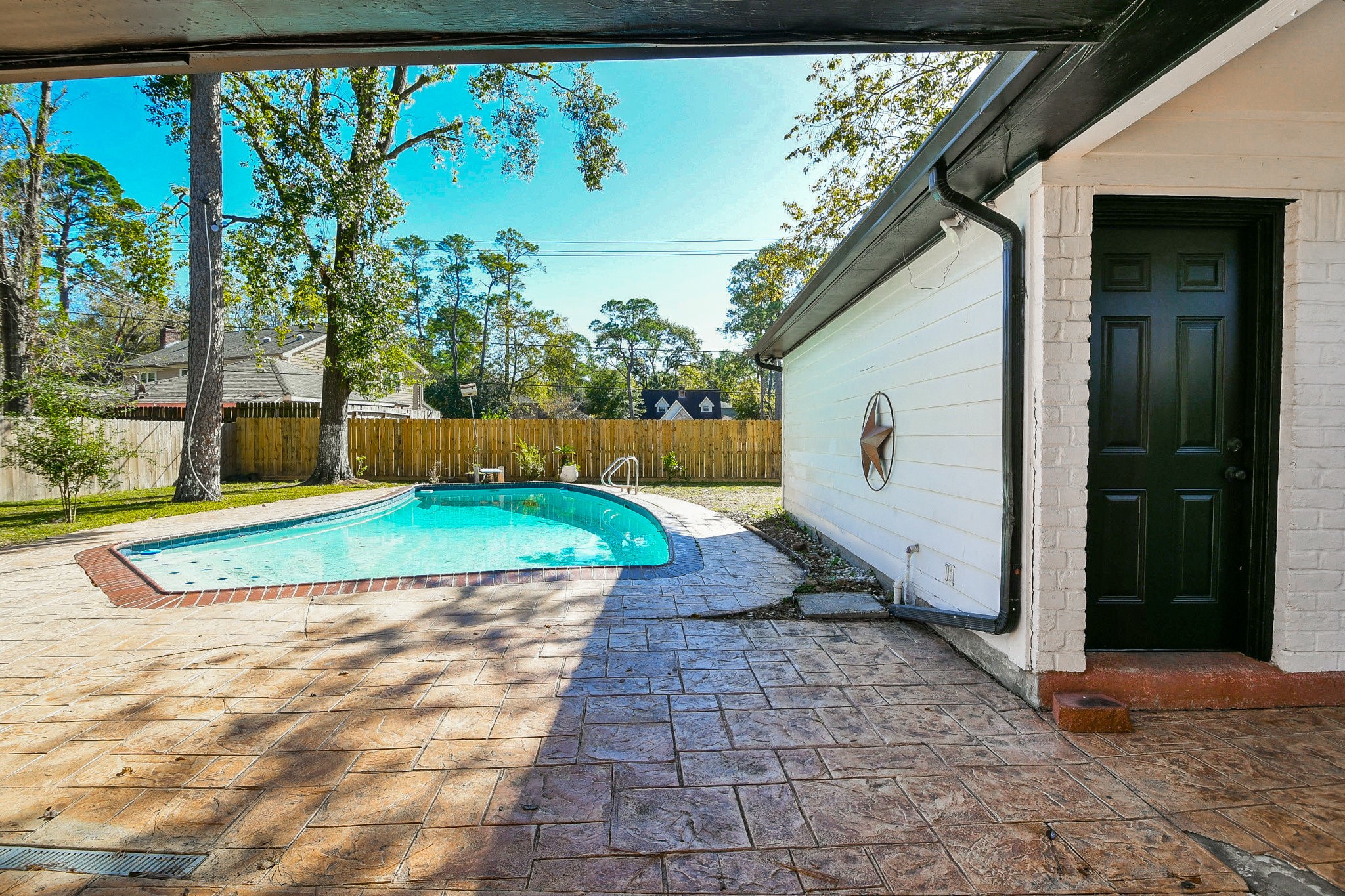 1007 Maranon Lane Houston, TX 77090 - Photo 31 of 36 Step outside to enjoy this beautiful, spacious backyard. All the flooring is stamped concrete, and please notice the newly installed back fence!