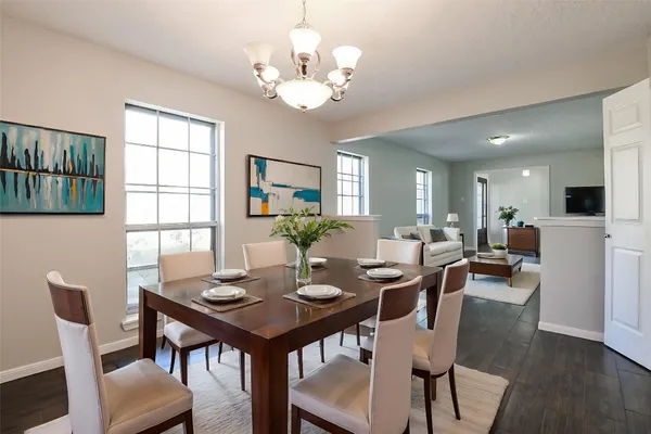 a view of a dining room with furniture and wooden floor