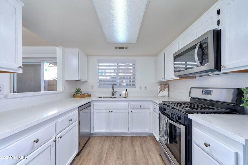 4508 Apricot Road, Unit B Simi Valley, CA 93063 - Photo 13 of 44 a kitchen with stainless steel appliances a sink stove and cabinets