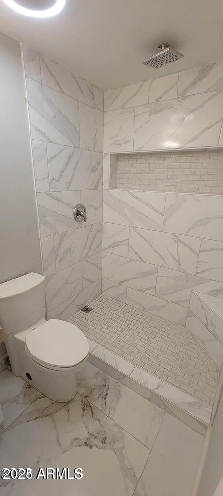 1826 North 73rd Avenue Phoenix, AZ 85035 - Photo 14 of 16 a bathroom with a toilet and a shower