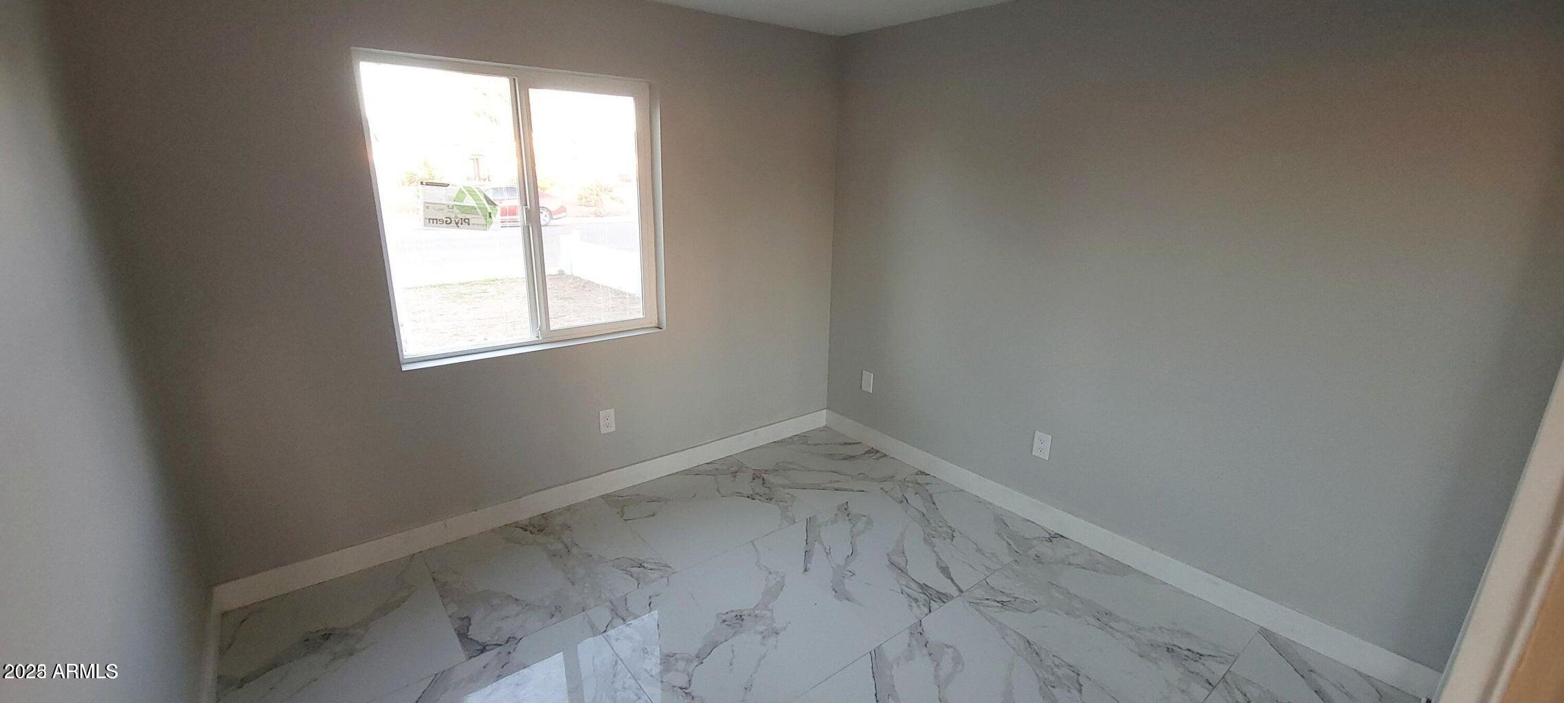 1826 North 73rd Avenue Phoenix, AZ 85035 - Photo 9 of 16 an empty room with a window
