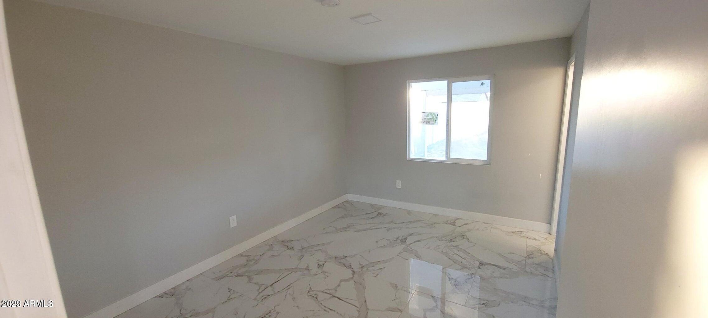 1826 North 73rd Avenue Phoenix, AZ 85035 - Photo 10 of 16 an empty room with windows