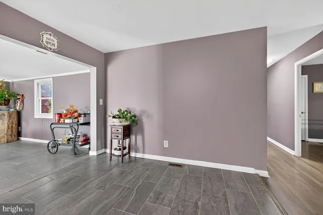 a view of a dining room with furniture and a potted plant