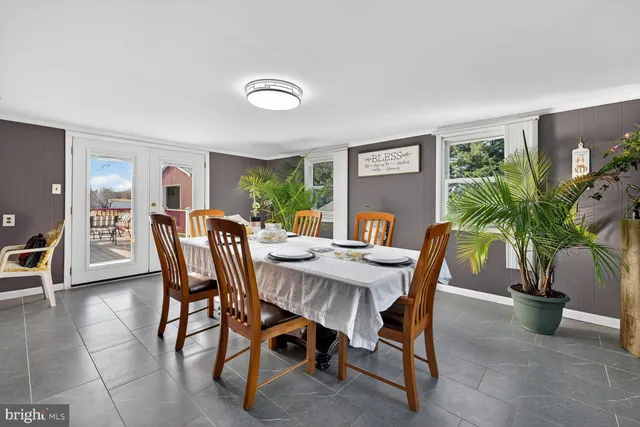 a view of a dining room with furniture and a potted plant