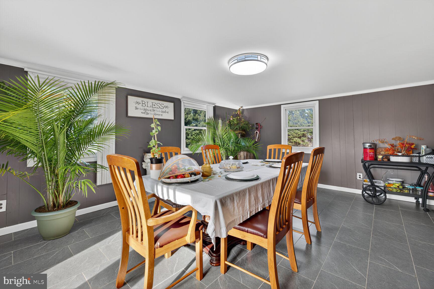 8418 Mapleville Road Boonsboro, MD 21713 - Photo 13 of 30 a view of a dining room with furniture and a potted plant