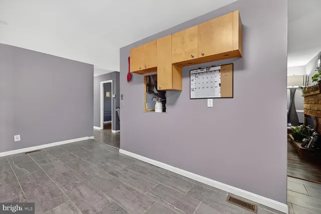 a kitchen with a refrigerator and a dining table