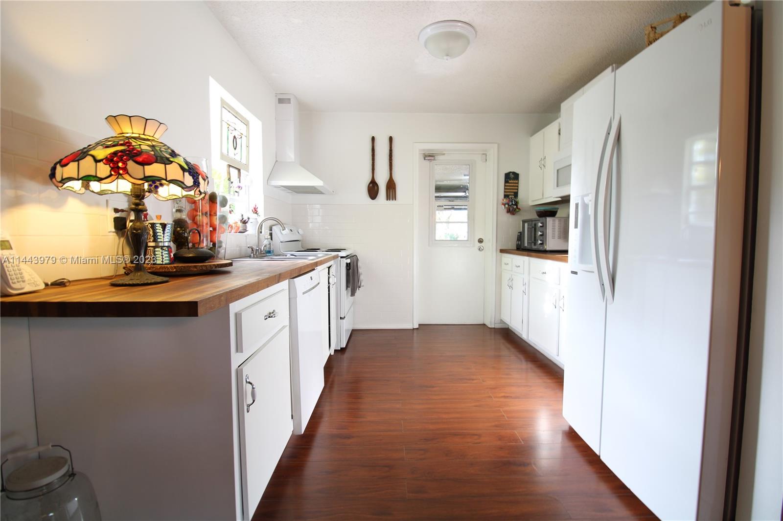 11370 Southwest 118th Street Miami, FL 33176 - Photo 14 of 26 a kitchen with stainless steel appliances a white stove top oven and a refrigerator