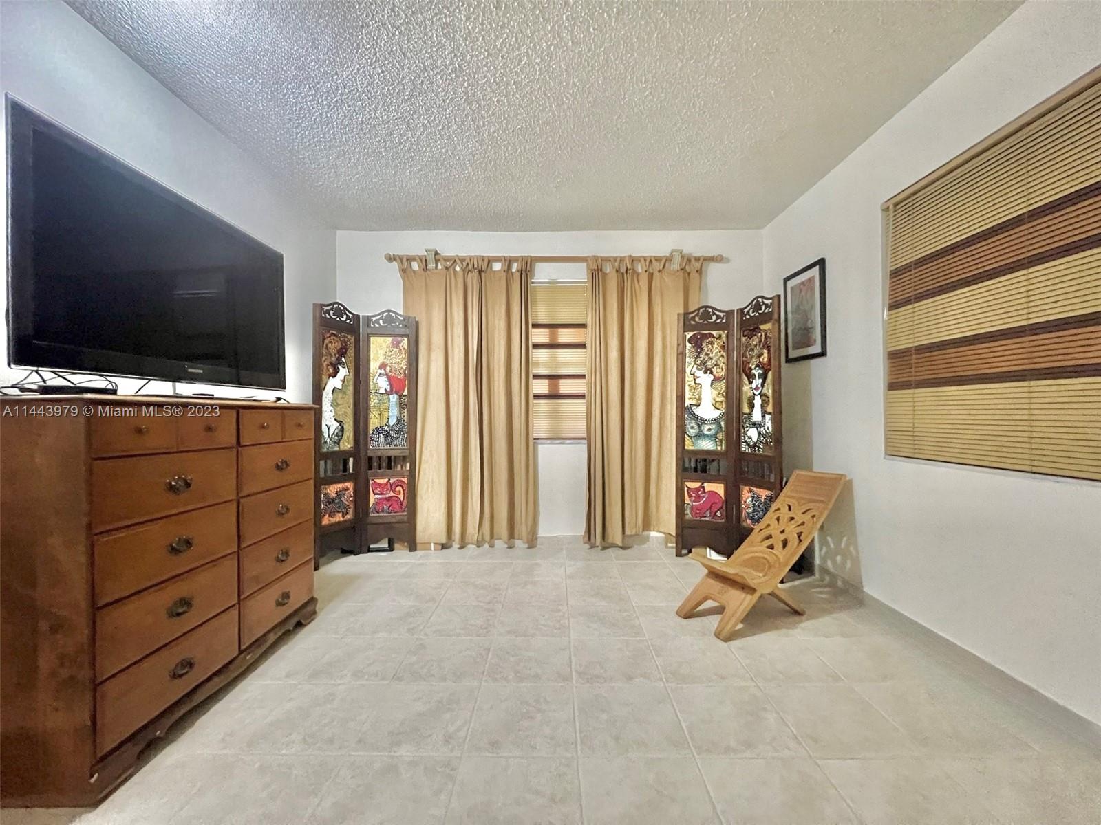 11370 Southwest 118th Street Miami, FL 33176 - Photo 16 of 26 a living room with furniture and flat screen tv