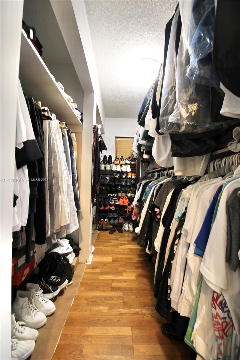 11370 Southwest 118th Street Miami, FL 33176 - Photo 17 of 26 a view of walk in closet with clothes and shoes