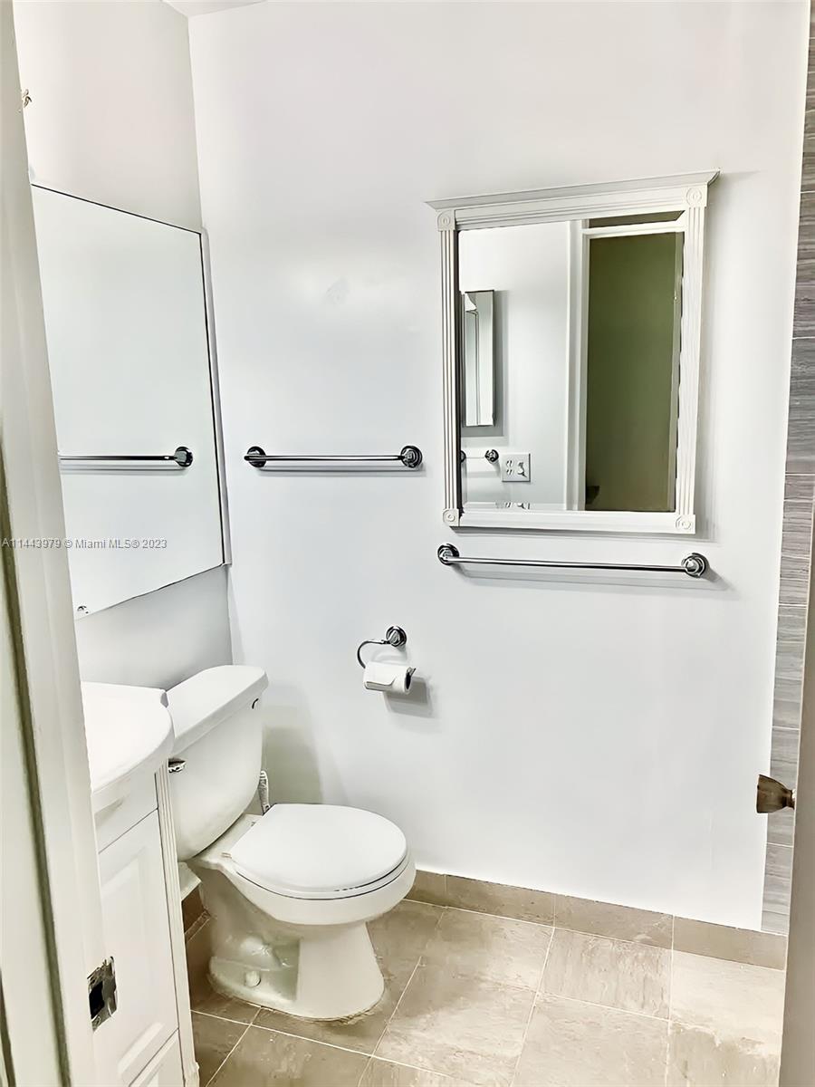 11370 Southwest 118th Street Miami, FL 33176 - Photo 20 of 26 a white toilet sitting next to a bathroom sink
