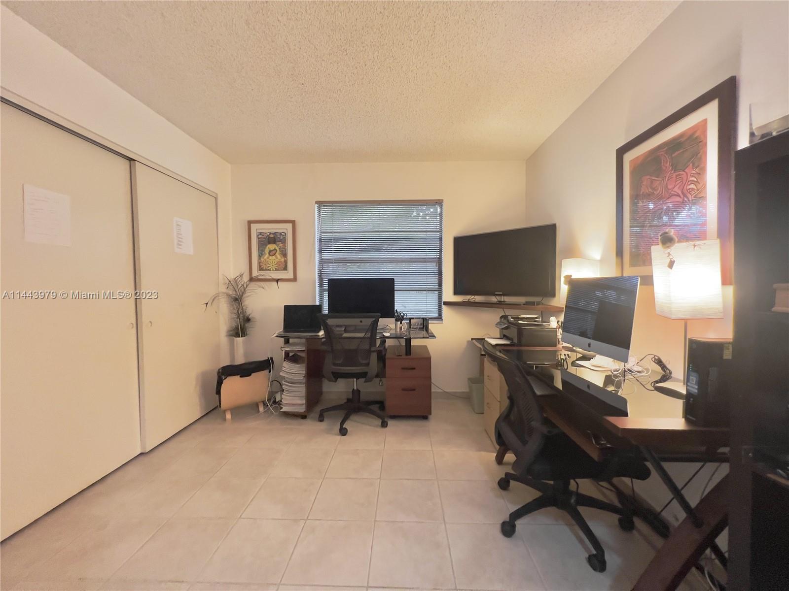 11370 Southwest 118th Street Miami, FL 33176 - Photo 24 of 26 a view of a workspace with furniture and a window