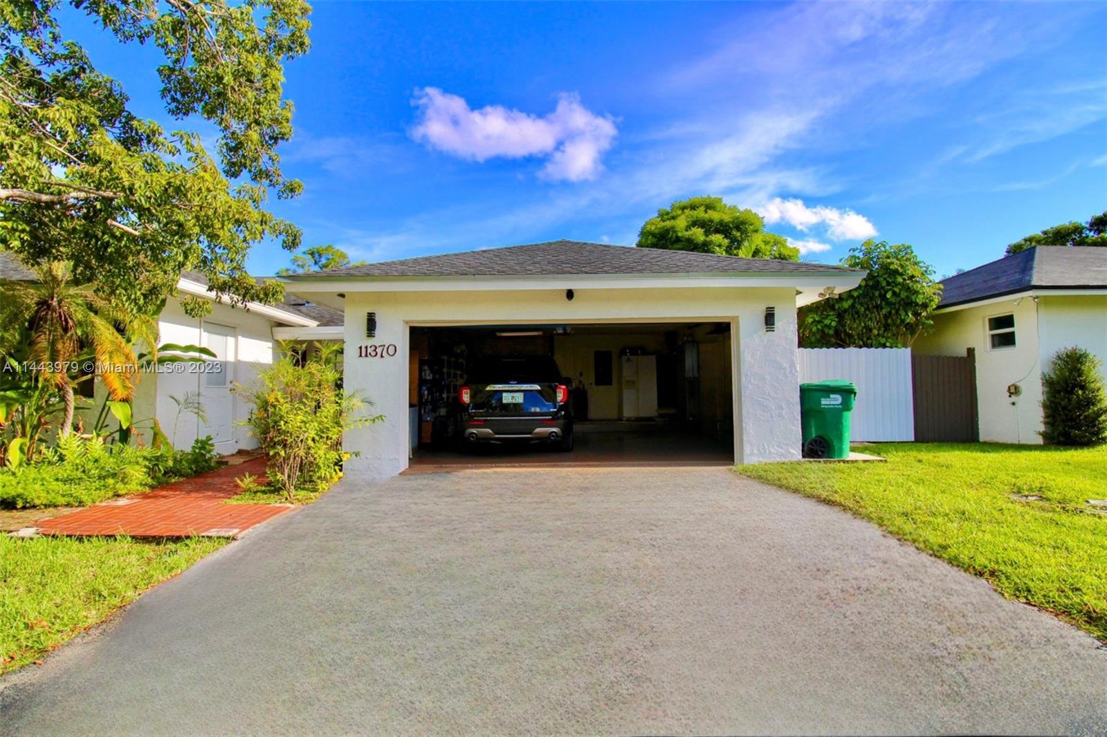 11370 Southwest 118th Street Miami, FL 33176 - Photo 4 of 26 a view of a car parked in front of a house