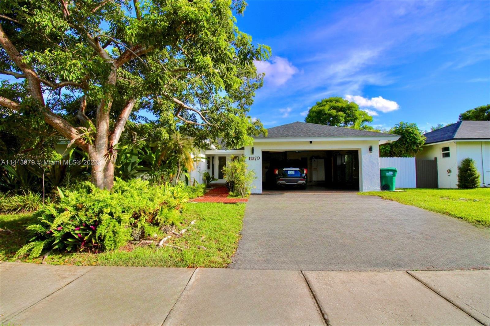 11370 Southwest 118th Street Miami, FL 33176 - Photo 5 of 26 a front view of a house with a garden