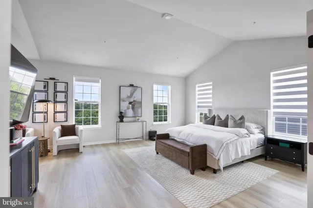 a bedroom with a large bed and a large window