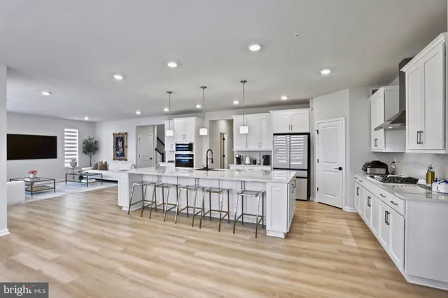 a large kitchen with stainless steel appliances lots of counter space and breakfast area
