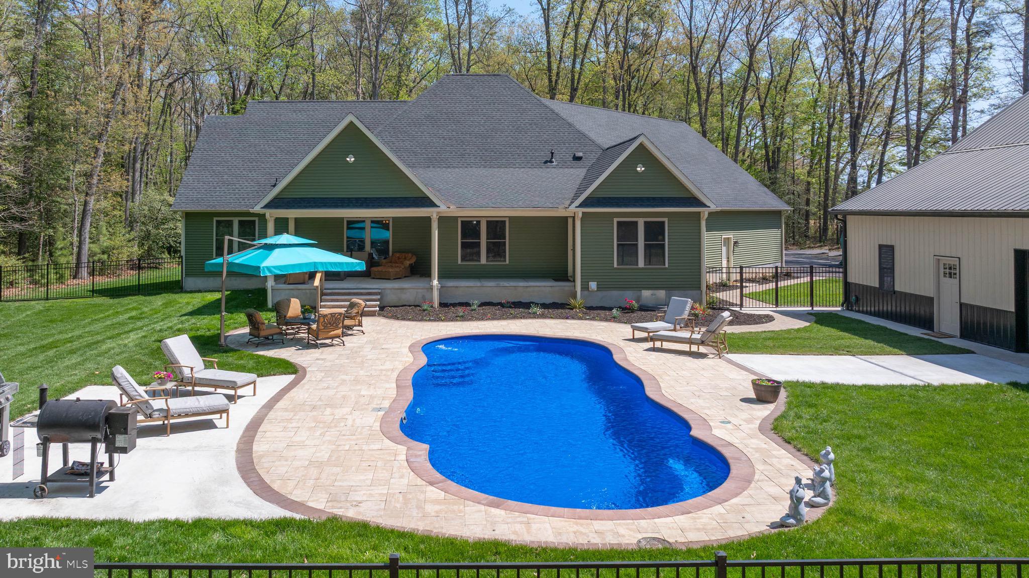 26750 Deep Branch Road Milton, DE 19968 - Photo 21 of 96 a view of house with garden space and swimming pool